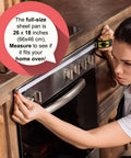 Woman measuring oven for full-size sheet pan with text overlay about pan dimensions.