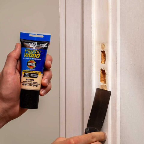 Using Plastic Wood All Purpose Latex Wood Filler Natural 3 Oz for quick interior and exterior wood fixes on door frame