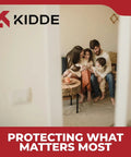 Family gathered on sofa smiling, seen through doorway, promoting Kidde security products with slogan 'Protecting What Matters Most'.