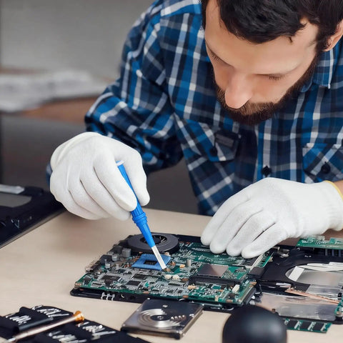 Man using Four Piece Ceramic Screwdriver Set With Non Conductive Slotted Tips And Anti Static Plastic Build For Safe Electronics Work on a circuit board.