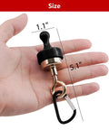 Hand holding Two Pack Heavy Magnetic Hooks For Outdoor Use with 15-pound capacity, showing compact size and black carabiner clip.