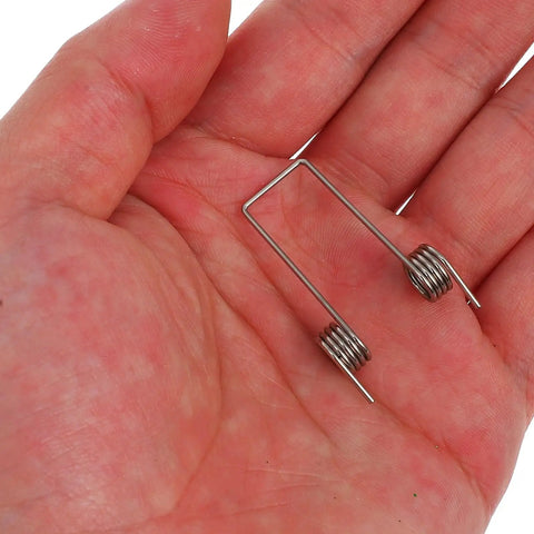 Cool 36 Piece Torsion Spring Assortment Kit Fix Your Flip Top Trash Cans With 9 Sizes For Easy Home Repair Woodworking And DIY Hacks To Get That Snappy Closure., silver metal torsion spring in hand