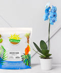 One Hundred Percent Organic Orchid Potting Bark Eight Quarts All Natural Pine Bark Mix Additive near blue orchid in pot