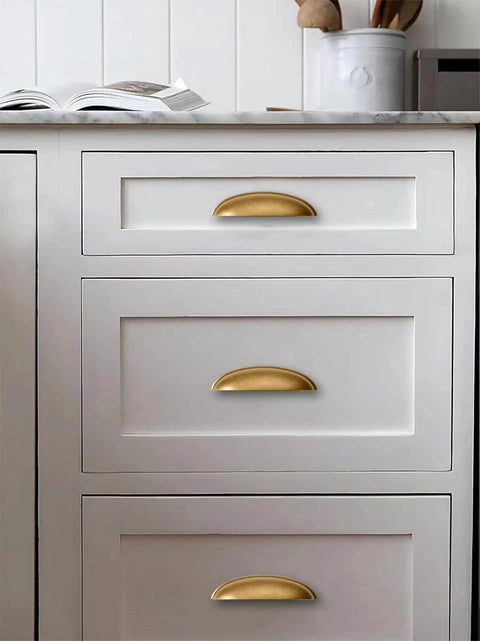 Top Shelf Antique Brass Cup Pulls For Kitchen Drawers 2 Pack on white kitchen drawers with marble countertop.