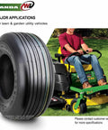 Set Of 2 13x5.00-6 Rib Turf Tires For Lawn Mowers And Utility Carts, 4 Ply Tubeless, 440 Lb Load, shown beside riding mower