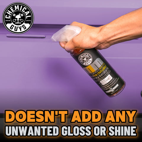 Meticulous Matte Finish Detailer and Spray Sealant for Satin and Matte Surfaces Quick Detailer That Keeps the Non Gloss Look Safe on Vinyl Wraps for Cars Trucks and SUVs 16 Oz bottle in hand on purple background