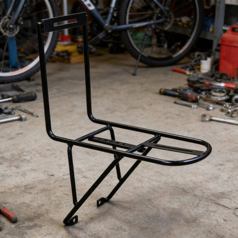 Front Fork Cargo Rack For Bikes in black steel, ideal for bikepackers and commuters, shown in garage setup, fits 34-40mm forks