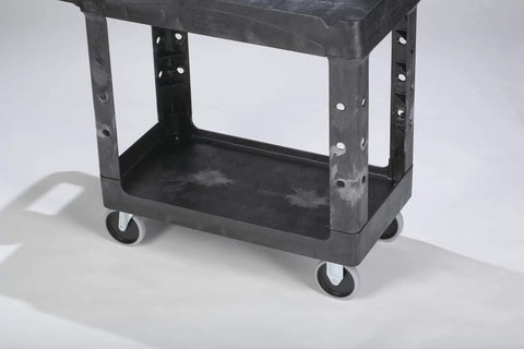 Top Tier Heavy Duty Two Shelf Utility Cart With Durable Structural Foam Lipped Trays And Smooth Glide Handles 500 Lb Capacity close-up of rolling cart wheels and tray.