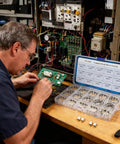 Technician using Metal Micro Momentary Tactile Push Button Switch Kit with 240 Pieces SMT 4x4mm Buttons, 14 Heights