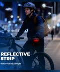 Cyclist at night with bike highlighting Women Bike Seat Cushion With Handle And Ergonomic 3 Zone Saddle Design Reflective Strip