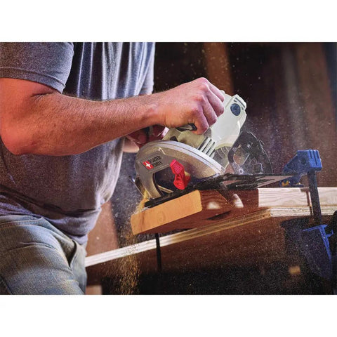 Person using Heavy Duty 7-1/4 Inch Circular Saw With 15 Amp Motor Delivers 5500 RPM Magnesium Shoe And Metal Guards For Durability Spindle Lock And Depth Adjustment For Fast Setup Lightweight 9.5 Lbs With Aux Handle For Clean Onsite Cuts cutting wood