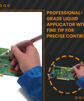 Hand using Pro Grade Flux Pen for electronics soldering on circuit board with fine tip applicator.
