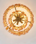 Artpad 19.69‑Inch Modern Ceiling Pendant Light, LED Living Room Lighting with amber glass and gold finish from above.