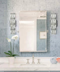 Chrome Crystal Wall Sconce With Four Lights Modern Tube Shape Glass Wall Light Fixture For Bedroom Living Room Hallway Kitchen And Vanity Sleek Dope Chrome Finish To Elevate Any Room beside a mirror.