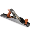 Professional Number 6 Smoothing Bench Plane Crafted From Solid Cast Iron With Precision Machined Frog And Ergonomic Bubinga Handle glides over wood.