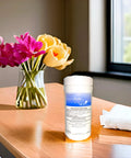 Audio Wipes cleaning towelettes large canister (160 wipes) on a wooden table beside a white towel and flower vase