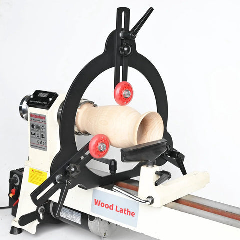 Wood lathe steady rest with black arch and red adjustment wheels, supporting a wooden spindle blank.