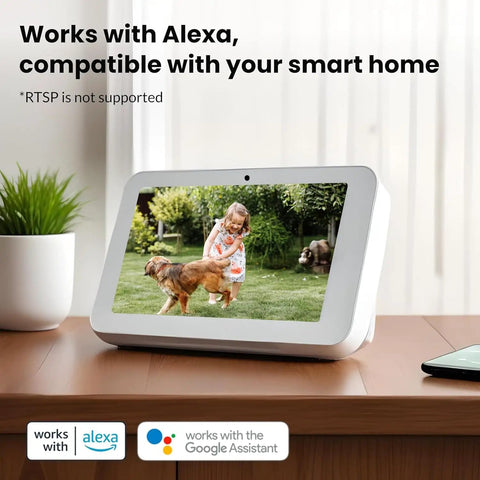 Smart display device showing a girl and dog in garden, works with Alexa, compatible with Google Assistant, on wooden desk.