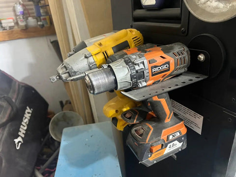 Magnetic Power Tool Organizer Wall Mount Rack with Cordless Drill Storage in Garage, holding two heavy-duty drills.