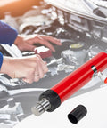 Close-up of red hydraulic floor jack pump with metal shaft and black knurled collar.