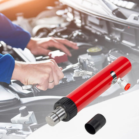 Close-up of red hydraulic floor jack pump with metal shaft and black knurled collar.