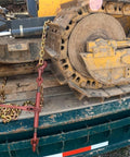 Heavy-Duty Grade 70 Transport Chain And Binder Kit securing equipment on a flatbed, showing lever-style binder in use