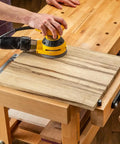 Using a sander on wood secured with 2 Inch Aluminum Round Bench Dogs With Beefy Side Spring For Thin Benchtops And Woodworking Tools.