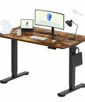 Rock Solid Sit Stand Desk 48 By 24 Inch One Piece Rustic Top Black Frame Electric Height Adjustable Computer Workstation with monitors and accessories.