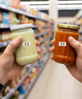 Hands holding jars with price stickers in a store aisle using Go-To 30,000 Price Gun Labels Pack With 60 Rolls Price Tag Stickers.
