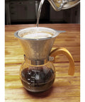 Next Level Pour Over Coffee Maker With Heat Resistant Borosilicate Glass Carafe being used with hot water pouring into it.