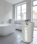 115L XXL Collapsible Laundry Hamper With Aluminum Soft Grip Handle in a modern bathroom setting