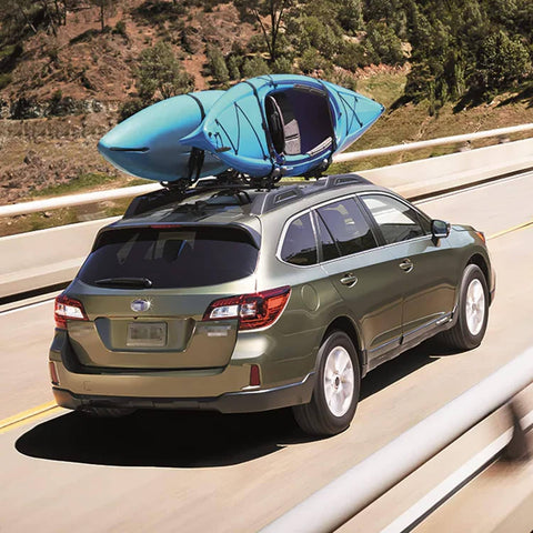 SUV with kayak on roof secured by Beefy 16 Foot Tie Down Straps With Rubber Padded Cam Lock Buckle, 1 Inch Wide, 600 Lb Working Load