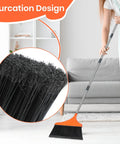 Four Pack Heavy Duty Angle Broom With Fifty Two Inch Handle and Tough Split Bristles for indoor cleaning on a hardwood floor.