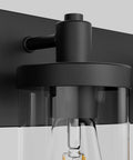 Close-up of Farmhouse Four Light Matte Black Vanity Light Fixture showcasing aluminum construction and clear glass shade detail.