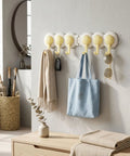 Heavy Duty Six Hook Adhesive Wall Rack With Smooth 180 Degree Swivel And Easy No Drill Mount holding a scarf, bag, and sunglasses.