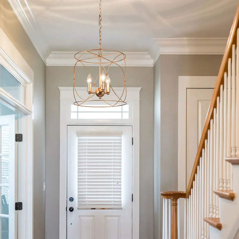 Gold Pendant Light With Cylindrical Lattice Cage Frame And Spherical Center Three Gold Candelabra Arms in entryway.