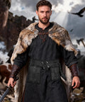 Man wearing Medieval Wide Belt Set With Leather Belt Large And Small Waist Pouches And Leather Sword Frog For LARP And Halloween Costumes Totally Ready Viking Or Knight All In One Accessory Kit Black Edition, holding sword, castle backdrop.