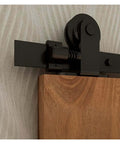 Close-up of Sliding Barn Door Hardware Kit 4ft To 20ft Rail System with industrial T style roller on wood door.