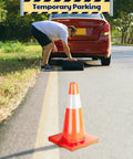 18 Inch Traffic Safety Cones 12 Pack Orange PVC With Reflective Collars Built For Parking Lot Traffic Control Driveway And Construction Sites Tough As Nails Heavy Duty Stable 11 By 11 Inch Base placed on roadside with car
