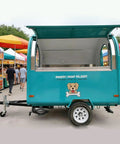 Custom Built Food Trailer With Flexible Layout Designed To Hit The Road For Busy Markets And Festival Vendor Lots Featuring Kickass Prep Space And Smooth Tow Setup For Hustling Grill Masters side view of turquoise food trailer at a festival