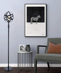 Globe Industrial Floor Lamp With Dimmable On Off Switch, Rustic Spherical Standing Light for Living Room next to artwork and sofa.