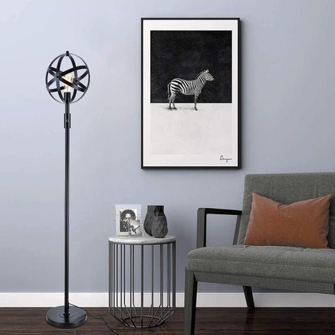 Globe Industrial Floor Lamp With Dimmable On Off Switch, Rustic Spherical Standing Light for Living Room next to artwork and sofa.