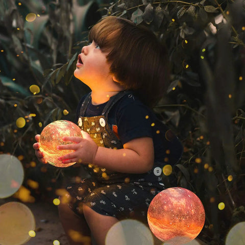 Child holding Lit Galaxy Moon Night Light With Stand And Remote, 3D Printed Moon Lamp In 16 Colors, kid safe