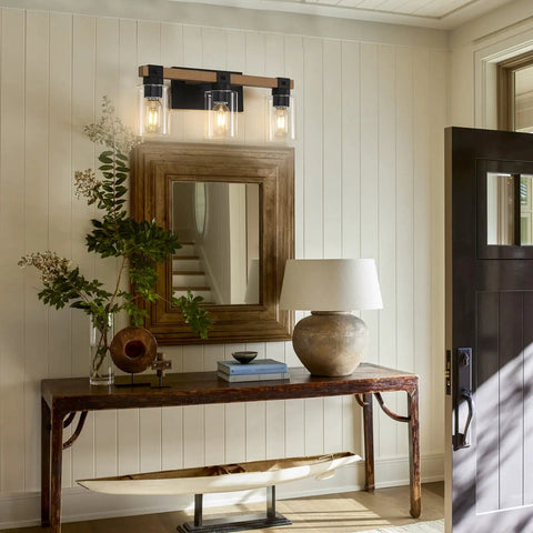 Farmhouse 3 Light Vanity Fixture With Rustic Wood And Clear Glass Shades Above Entryway Table and Mirror