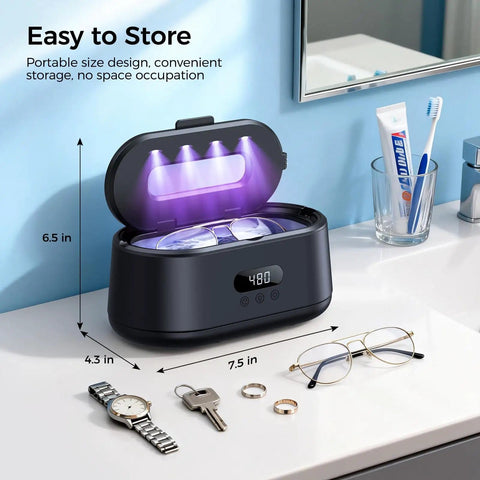 50KHz Ultrasonic Jewelry Cleaner With Dual Modes And LED Display on bathroom counter beside eyeglasses, rings, and watch.