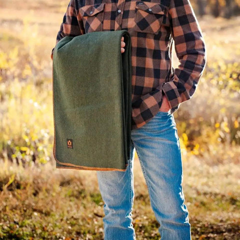 Person holding Beefy Warmth And Rugged Durability Military Wool Blanket For Outdoors Camping Picnics Travel Stadium Events And Survival Kits