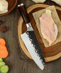 Beast Mode 7 Inch Meat Cleaver For Kitchen Prep with 5Cr15Mov steel blade on wooden board with sliced vegetables and garlic