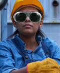 Person wearing Badass Welding Glasses With Anti Glare Black And Gray Lenses for industrial use, with safety gloves.