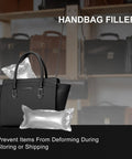 Black handbag with inflatable air pillows for shaping, displayed on shelf with other handbags in store setting.