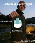 Person holding 20W LED Camping Lantern Rechargeable, 1200LM Output, 3000mAh Battery; tent in background, evening setting.